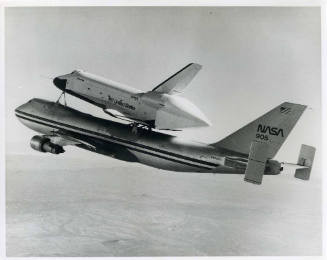 Black and white photograph of Enterprise atop NASA-905 above Mojave, CA