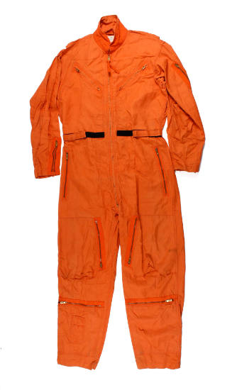 U.S. Navy orange flight suit laid flat, high collar, numerous pockets and adjustable Velcro at …