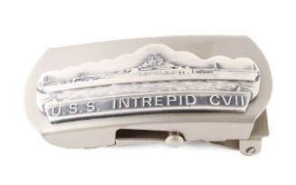 Silverbelt buckle depicting aircraft carrier at sea with “U.S.S Intrepid CVII” on a ribbon belo…