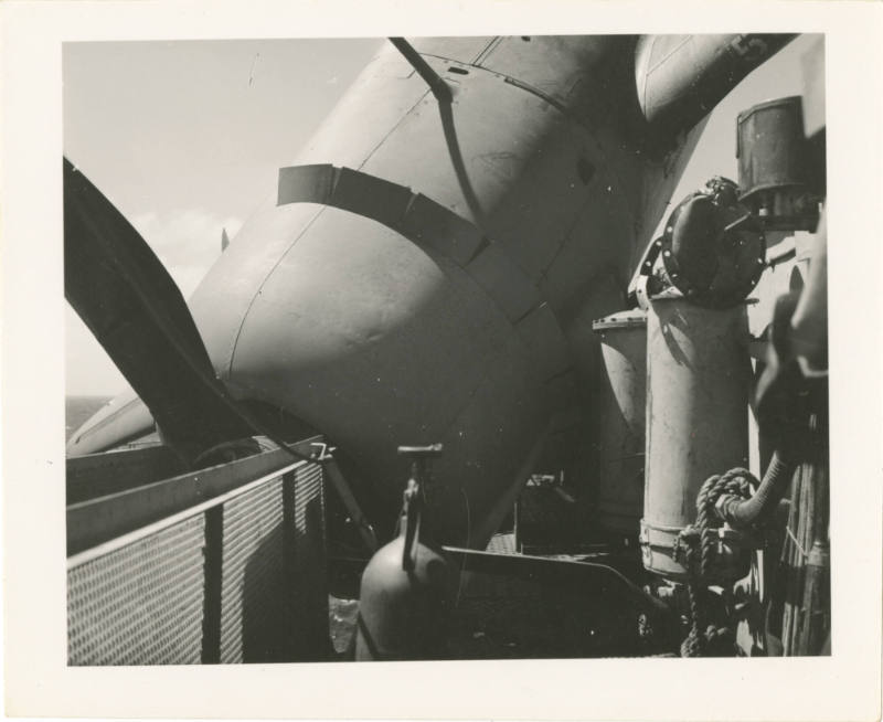 Black and white photograph of an airplane that taxied off the edge of the flight deck with the …