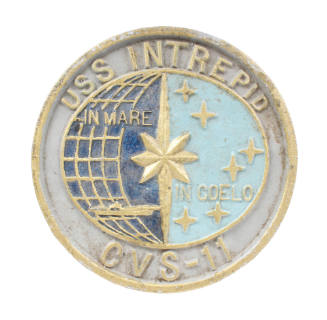 Painted, circular metal plaque depicting the seal of the aircraft carrier USS Intrepid