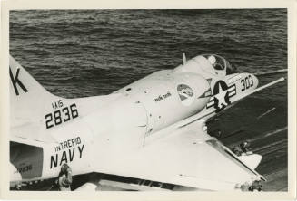 Printed black and white photograph of a Douglas A-4C Skyhawk on the flight deck