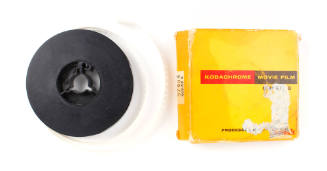 Super 8 film reel and yellow cardboard box