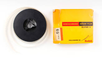 Color photograph of film reel and film box