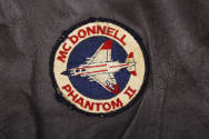 Detail of circular red, white and blue McDonnell Phantom II patch with image of airplane