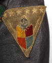 Detail of triangular Carrier Air Wing 6 patch with knight helmet, shield and stars