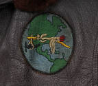 Detail of circular Naval Air Ferry Command patch with stork carrying an airplane in front of gl…