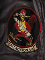 Detail of circular Attack Squadron 66 insignia patch with red rooster holding an anti-aircraft …