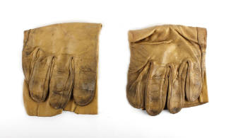 Fold pair of camel colored leather gloves