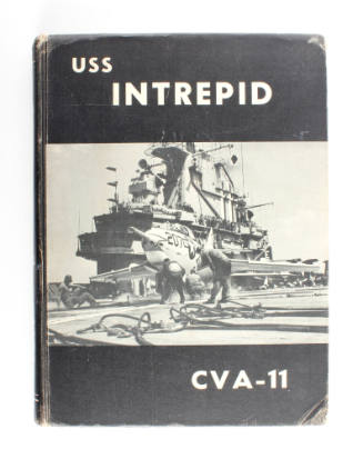 Black hardcover USS Intrepid yearbook with black and white photograph of the flight deck