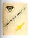 Hardcover tan yearbook for Guided Missile Group Two, 1958, with a drawing of a torpedo