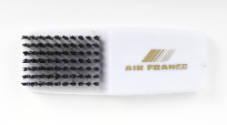 White plastic hairbush with gold Air France logo on handle