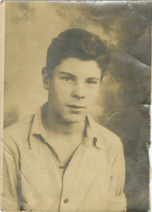 Black and white photograph of a man in a button down shirt looking at the camera