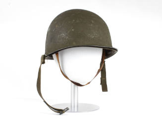 Olive drab military helmet and liner with chin straps on mannequin head form