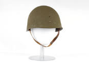 Olive drab helmet liner with chin strap on mannequin head form