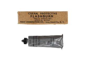 Gray tube of flash burn cream and cardboard packaging box