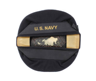 Round dark blue flat hat with ribbon that says U.S. Navy in gold