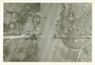 Black and white aerial reconnaissance photograph showing damaged bridges and bomb craters