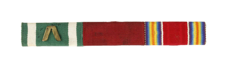 Three ribbons on a ribbon bar, with an inverted bronze “V” on the ribbon at left
