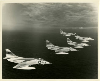 Black and white photograph of five A-4 Skyhawks flying in formation