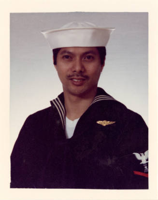 Color portrait of Gofrido Garcia wearing a U.S. Navy uniform and white cap