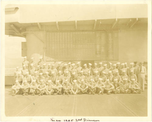 Black and white group photograph of USS Intrepid's second division posed in three rows on the f…