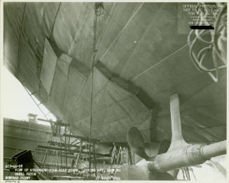 Black and white photograph of a patch on the hull of USS Intrepid in dry dock 