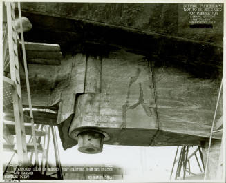Black and white photograph of damage to USS Intrepid’s cracked rudder post housing in dry dock