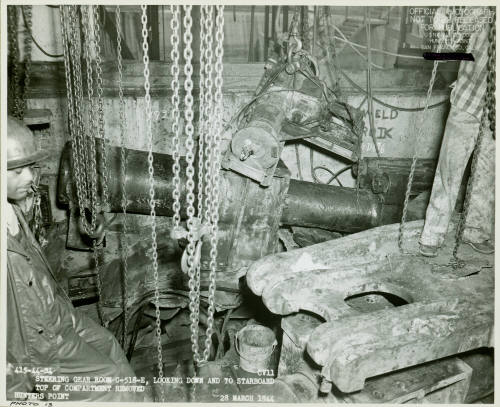 Black and white photograph of steering gear room on USS Intrepid during repairs