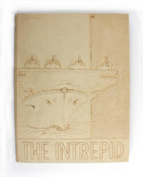 Tan hardcover USS Intrepid cruise book for 1943 with a raised image of USS Intrepid and aircraf…