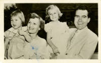 Printed postcard with a black and white photograph of the Nixon family