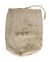 Front view of white canvas drawstring bag with black stamps