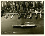 Printed black and white photograph of USS Intrepid on the East River in New York