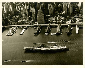 Printed black and white photograph of USS Intrepid on the East River in New York
