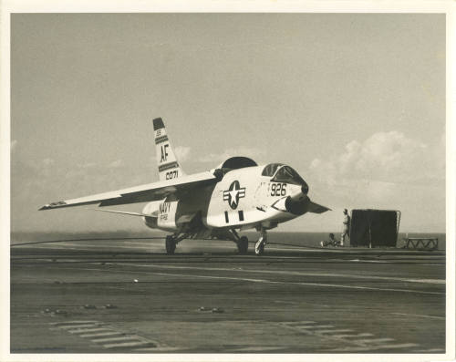 Printed black and white photograph of a Vought F8U-1P Photo Crusader on Intrepid's flight deck