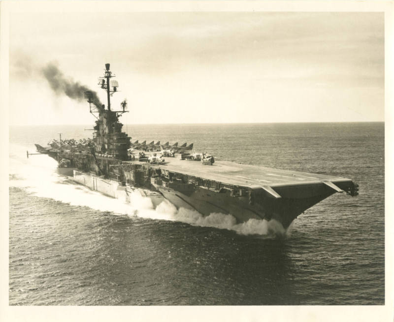 Printed black and white photograph of USS Intrepid at sea