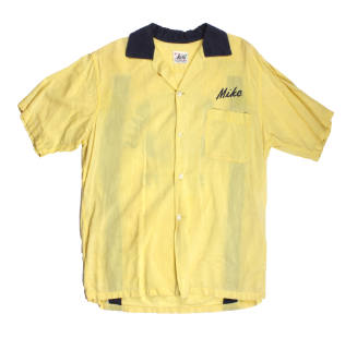 Front of yellow bowling shirt with blue collar and the word "Mike" above left pocket