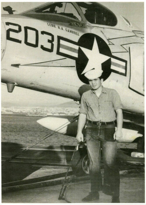 Printed black and white photograph of Michael Reppucci wearing dungarees and a white enlisted h…