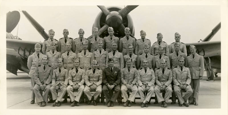 Printed black and white photogrph of a squadron in front of an aircraft