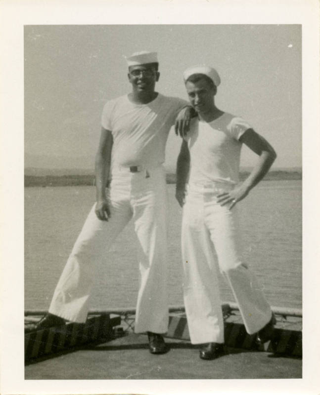 Printed black and white photograph of two enlisted sailors smiling at the camera on the flight …