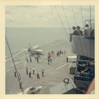 Color photograph of an A-4 Skyhawk launching off of Intrepid's flight deck