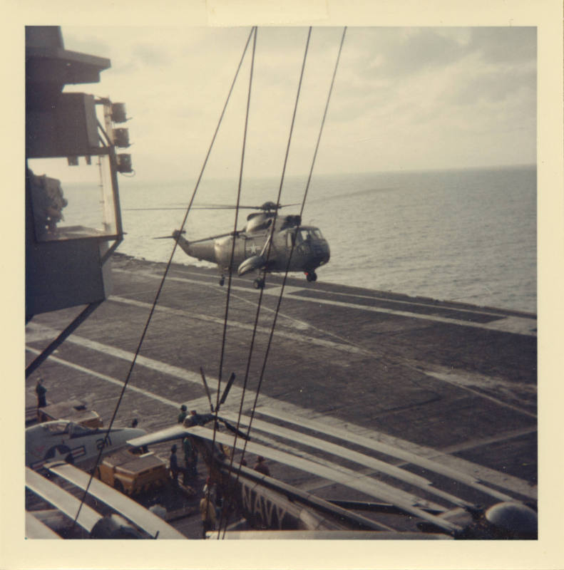 Color photograph of a SH-3A Sea King landing on Intrepid's flight deck