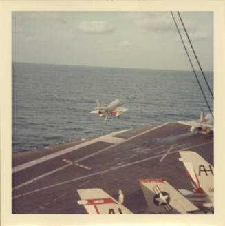 Color photograph of a Douglas A-4 Skyhawk launching off Intrepid's flight deck
