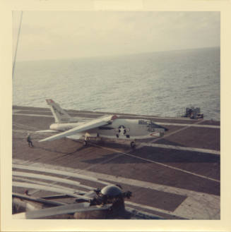 Color photograph of a F-8 Photo Crusader on Intrepid's flight deck