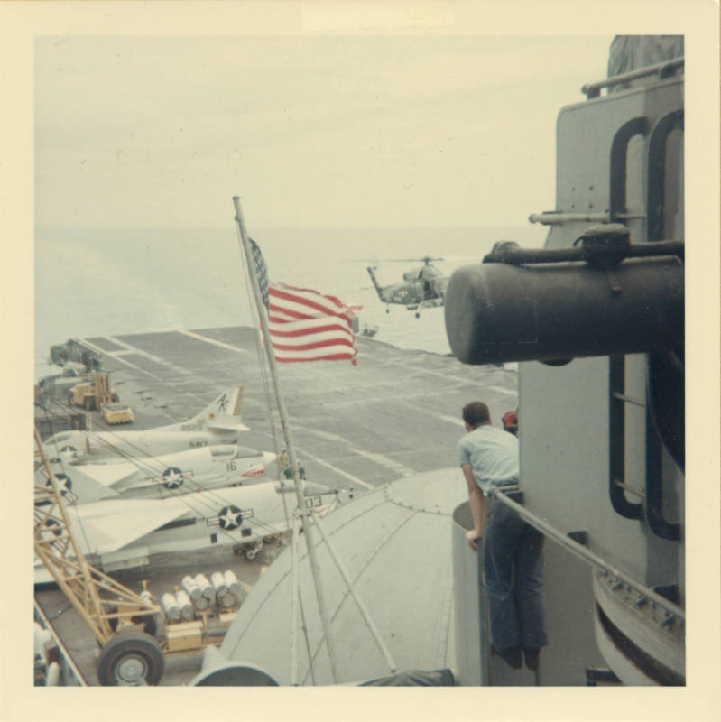 Color photograph of a Sea Sprite lifting off from Intrepid's flight deck