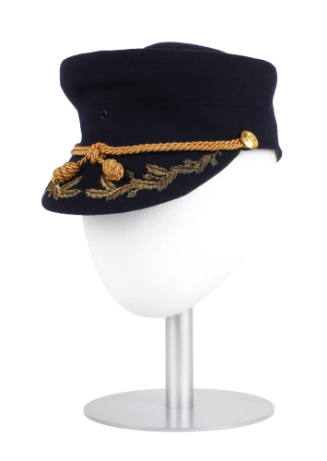 U.S. Marine Corps women's blue hat with gold cord and embroidery, displayed on a hat stand