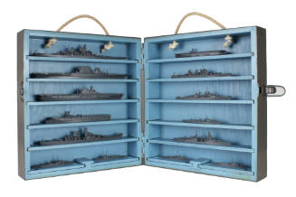 Open case of U.S. Navy ship recognition models with seven stacked vertically on each side, ship…