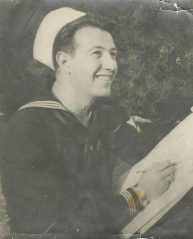 Printed black and white photograph of Gilbert J. Farmer holding a pad of paper and a pencil