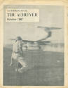 Black and white photograph of flight deck crew member directing an aircraft on the flight deck …