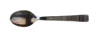 Tarnished silver teaspoon with crown on handle